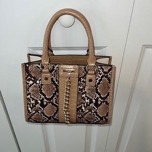 Also snake skin top handle bag.